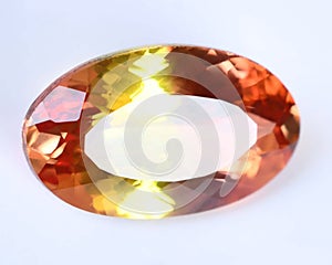 Natural gemstone orange Padparadscha sapphire on gray background photo