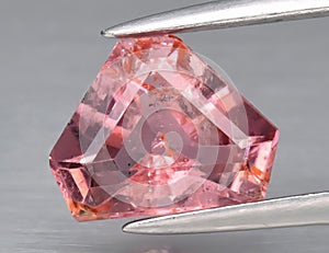 Natural gem pink tourmaline on gray background