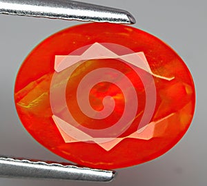 Natural gemstone fire opal on gray background