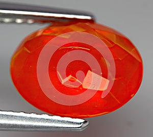 Natural gemstone fire opal on gray background