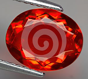 Natural gemstone fire opal on gray background