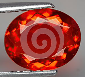 Natural gemstone fire opal on gray background