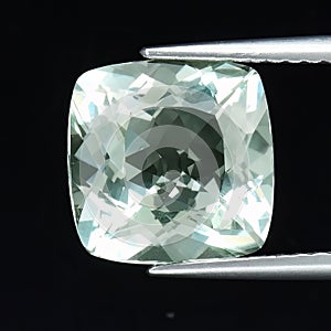 Natural gemstone green amethyst prasiolite on gray background