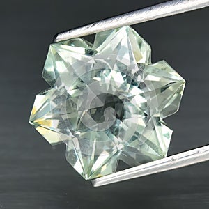 Natural gemstone green amethyst prasiolite on gray background