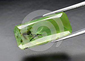 Natural gemstone green prehnite on gray background