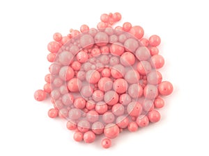 Natural gemstone pink coral beads on a white background
