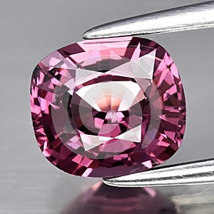 Natural gemstone pink spinel on gray background