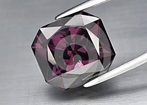 Natural gemstone pink spinel on gray background