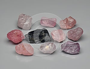 Natural gemstone pink spinel on gray background