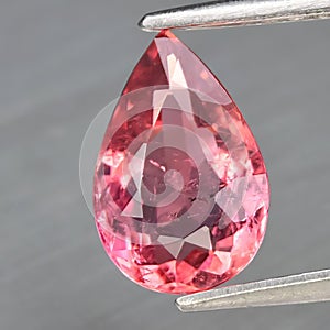 Natural gemstone pink tourmaline on gray background