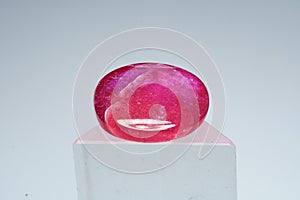 Natural gemstone ruby on a stand white background photo