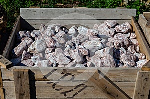 Natural granite stone in a large wooden box