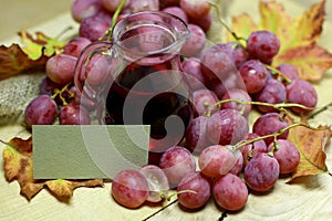 Natural grape red juice in glass jug and paper card label