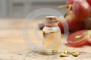 Natural grape seed oil on table, space for text. Organic cosmetic