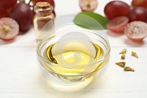 Natural grape seed oil on white table. Organic cosmetic