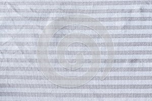 Natural gray striped linen fabric texture. Rough crumpled burlap textile background