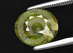 natural green garnet grossular gem on the background