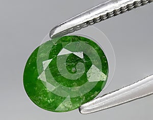 natural green grossular garnet gem on the background