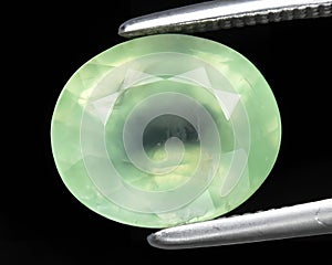 natural green prehnite gem on the background