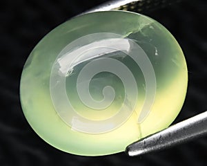 natural green prehnite gem on the background