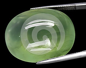 natural green prehnite gem on the background