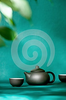 Natural green tea concept, dark teapot, and tea bowls