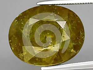 natural green yellow grossular garnet gemstone on the background