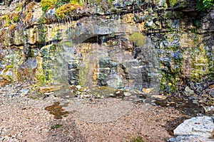 Natural ground water weeping through a sandstone wall