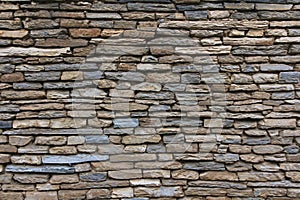 Natural grunge brown stone wall background and texture.