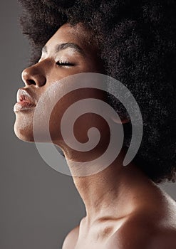 Natural hair care, profile and black woman with afro hairstyle, beauty and skincare on grey background. Natural haircare