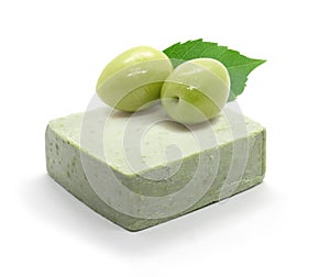 Natural handmade olive oil soap and two olives on white background