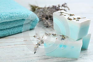 Natural handmade soap bars on white wooden table, closeup. Space for text