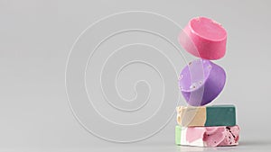Natural handmade soap. Bright pieces of soap balance on a grey background. Copy space