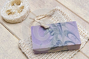Natural handmade soap with lavender and essential oil on wooden background. Zero waste concept