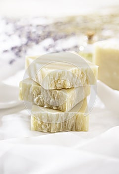 Natural handmade soap with lavender flowers on white silk. Aromatic natural soap. Organic soap