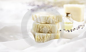 Natural handmade soap with lavender flowers on white silk. Aromatic natural soap. Organic soap