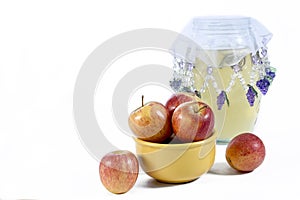 Natural and healthy apples tropical fruit inside a yellow pot isolated on bench background