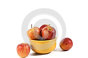 Natural and healthy apples tropical fruit inside a yellow pot isolated on bench background photo