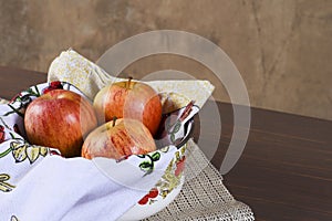 Natural and healthy tropical fruit apple in the bowl on the table on blurred texture background