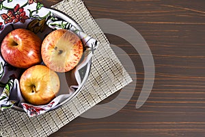 Natural and healthy tropical fruit apple in the bowl on the table on blurred texture background