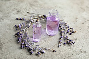 Natural herbal oil in glass bottles and lavender flowers