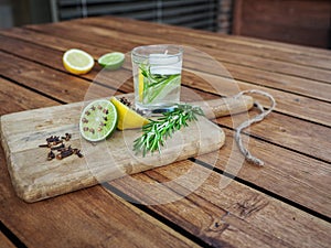 Natural homemade repellents on wooden table. Lime and lemon with cloves