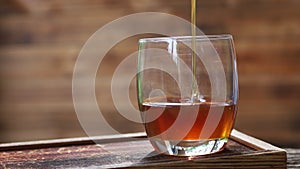 Natural honey dripping into a glass