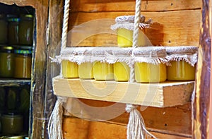 Natural honey in jars on a wooden shelf, souvenir rustic market