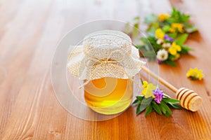 Natural honey in a pot or jar with twine tied in a bow