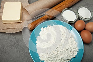 Natural ingredients for a delicious cake on a gray table