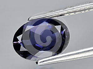 natural iolite kordierite gem on the background