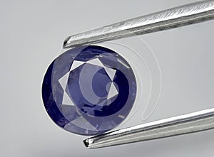 natural iolite kordierite gem on the background