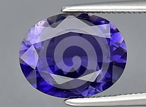 natural iolite kordierite gem on the background