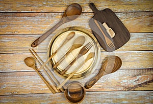 Natural kitchen tools wood products / Kitchen utensils background with spoon fork chopsticks bowl plate cutting board object , top